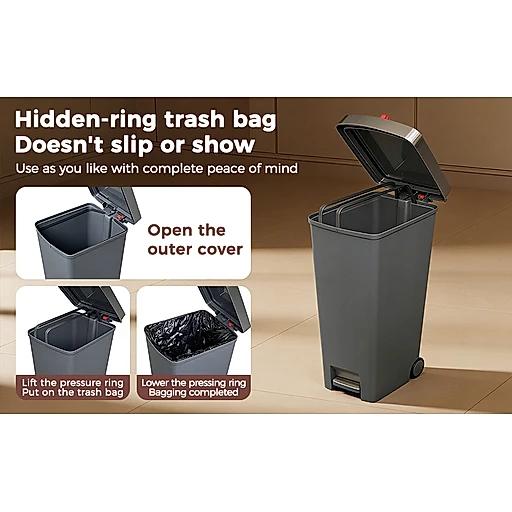 Gray trash bin with step-on lid mechanism on a wooden floor.