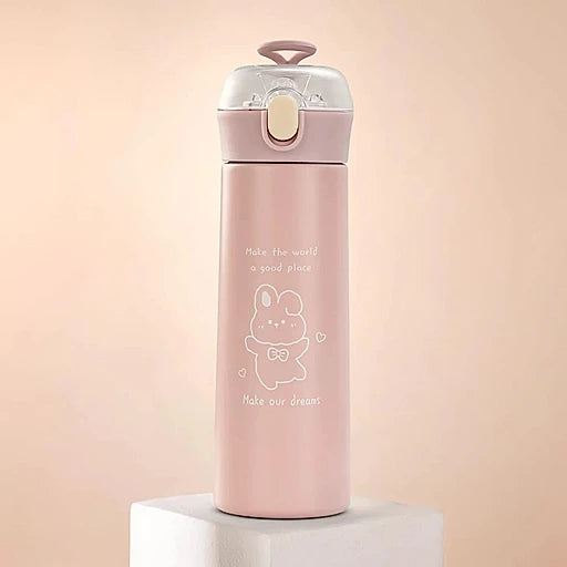 Pink water bottle with a cartoon design on a light pink background
