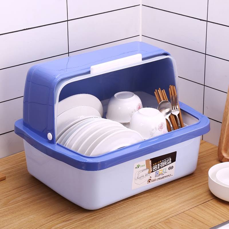 A blue and white plastic dish rack with a hinged lid, shown holding white bowls, plates, and wooden chopsticks, set on a wooden countertop against a white tiled wall.