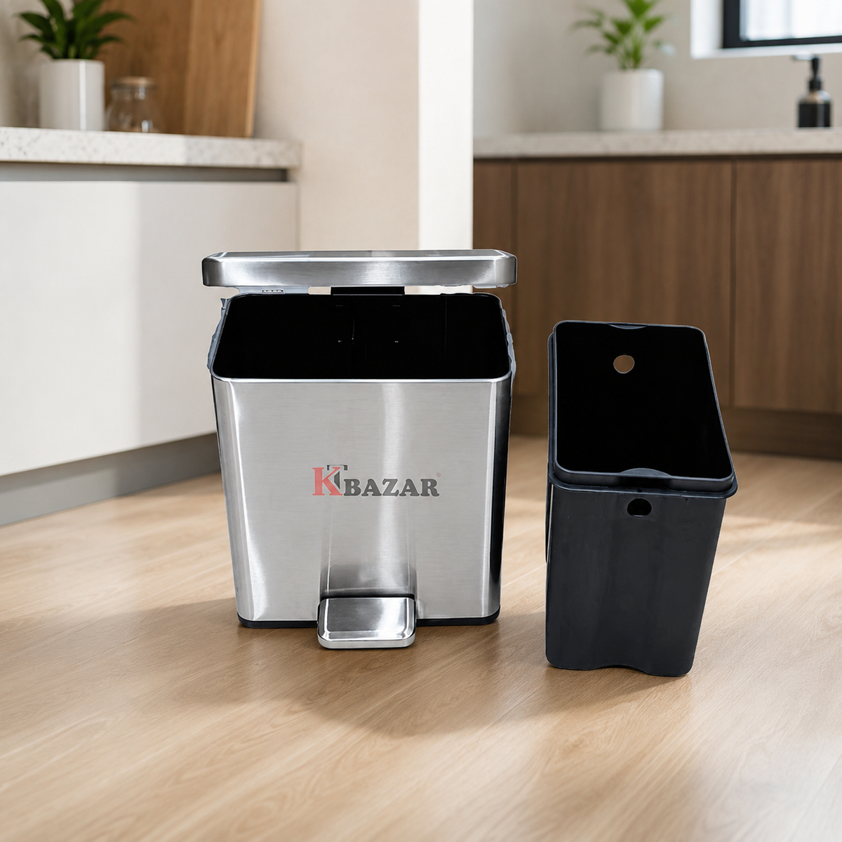 A stainless steel and black plastic two-piece waste bin set with a foot pedal, shown on a light wood floor in a kitchen setting. The brand name 'KTBAZAR' is printed on the front of the bin.