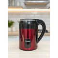 Red electric kettle with black handle on a kitchen counter
