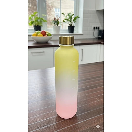 Gradient water bottle with gold cap on a kitchen counter