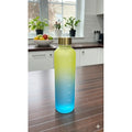 Gradient blue to yellow water bottle on a kitchen counter