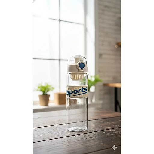 Clear water bottle with 'sports' text on a wooden table near a window.