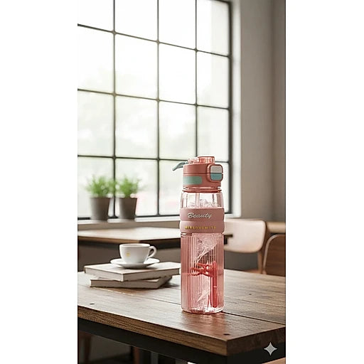 Pink water bottle with a bow on a wooden table in a bright room with large windows.