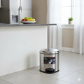 Stainless steel trash can with a label in a kitchen setting