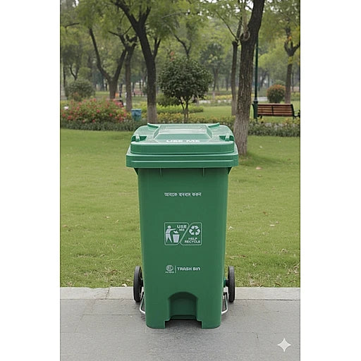 Green recycling bin in a park setting with trees and grass.