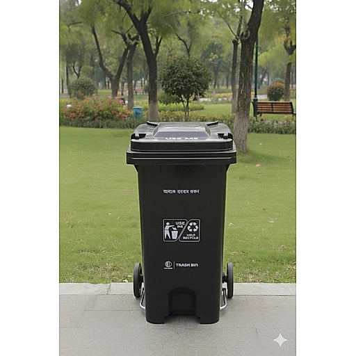 Black trash bin with recycling symbols in a park setting