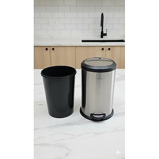 Black trash can and stainless steel pedal bin on a kitchen counter.