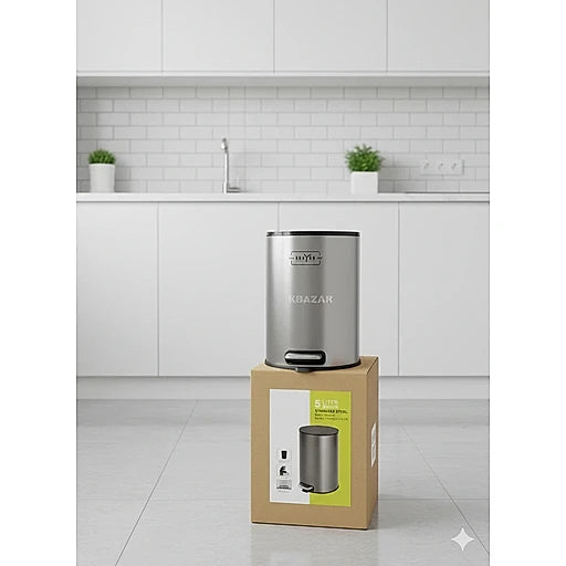 Silver kitchen trash can on a cardboard box with a kitchen background