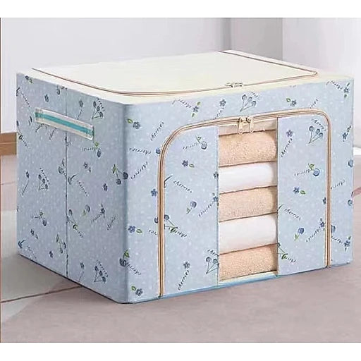 Floral-patterned storage box with folded clothes inside on a light background